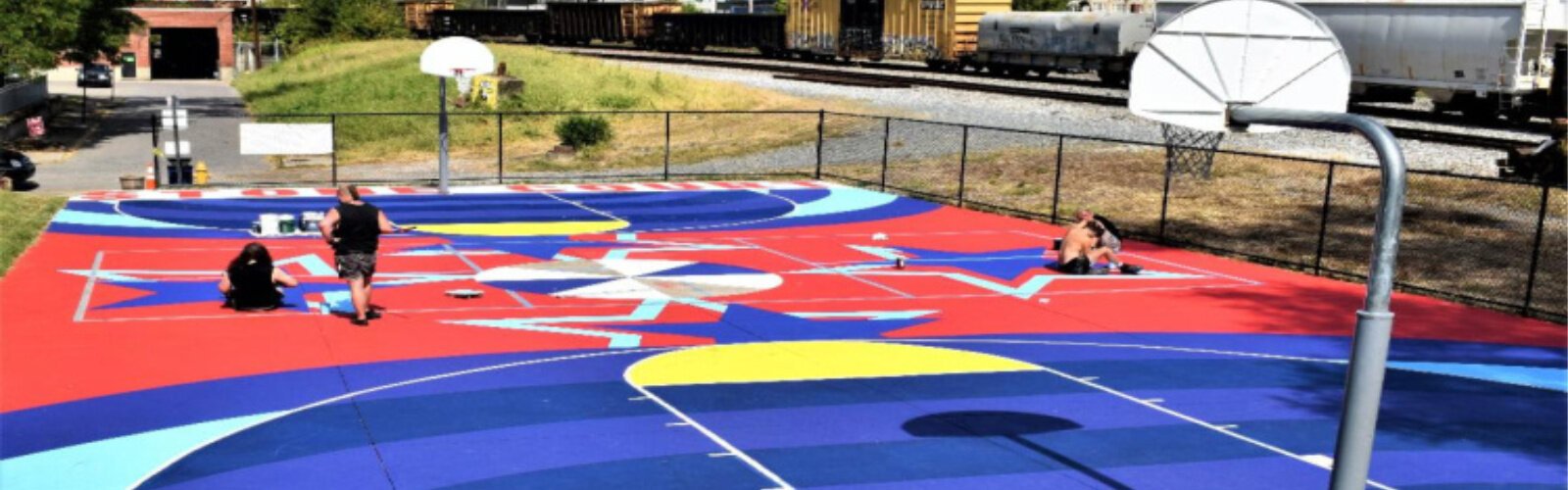 Sam Becker, Thad Becker, Alexander Giehl, and Jarrod Becker - all of Covington design firm BLDG Refuge - paint the mural on George Stone Court.