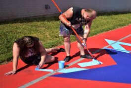 Sam and Thad Becker fill in one of the six colors at George Stone court.