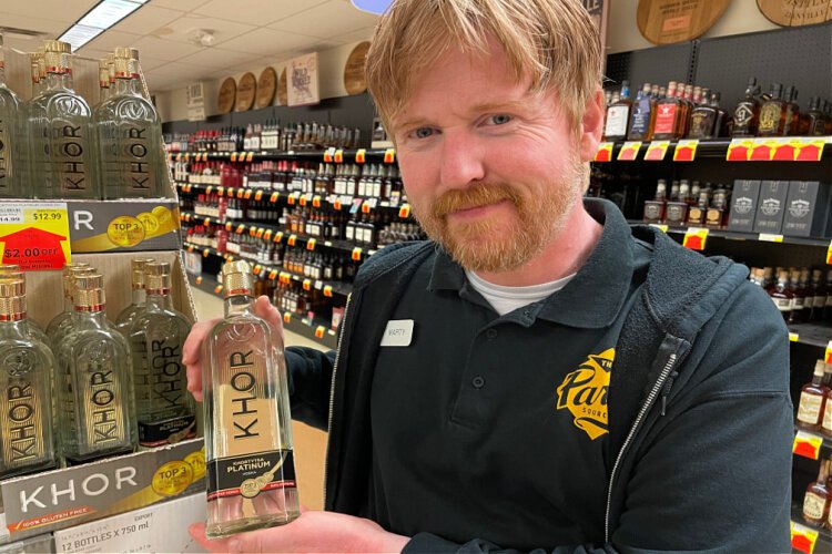 Marty Holland, manager at Party Source in Bellevue, with the Ukrainian vodka Khor. The store is sharing proceeds from its sale to Matthew 25 Ministries.