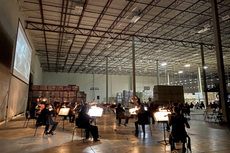 Amidst pallets of products waiting to be shipped, the Kentucky Symphony Orchestra played Schoenberg.