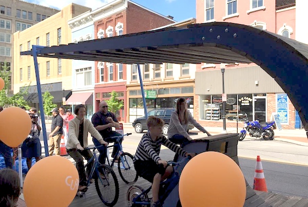 This Curb'd installation in front of Inspirado asks people to pedal bikes to power a movie projector