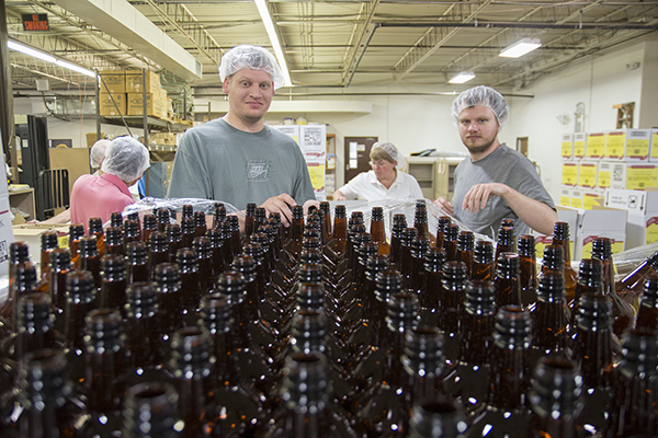 Justin May (left) and Aaron Dorsey do assembly work at BAWAC's warehouse facility in Florence