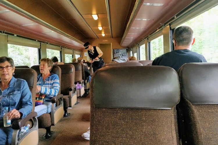 Riders sit in a coach car originally built for the Delaware, Lackawanna, and Western Railroad in 1930 by the famed Pullman Company.