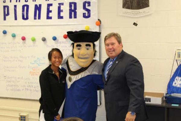 Kendal Burns of Simon Kenton poses with Thomas More President David A. Armstrong and Saints Mascot “Tommy Mo”