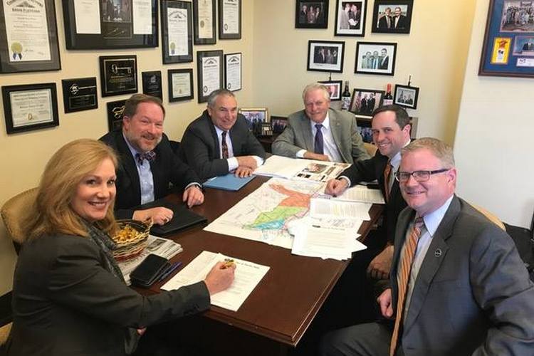 Independence Mayor Chris Reinersman, at left in bow tie, meets in Frankfort with legislators and other area leaders to discuss plans for the State Route 536 project.